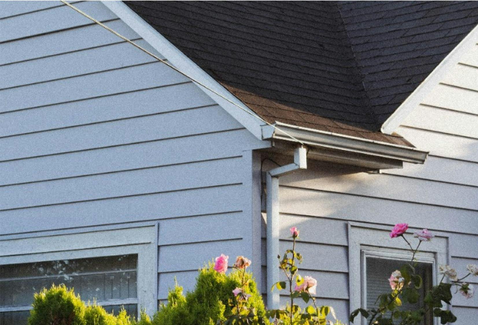 Emergency Storm Services | Reliable Roofers | Durable Roofing Systems | Trusted Residential and Commercial Roofers | Side view of home, focused on gutter downspout and roof angle