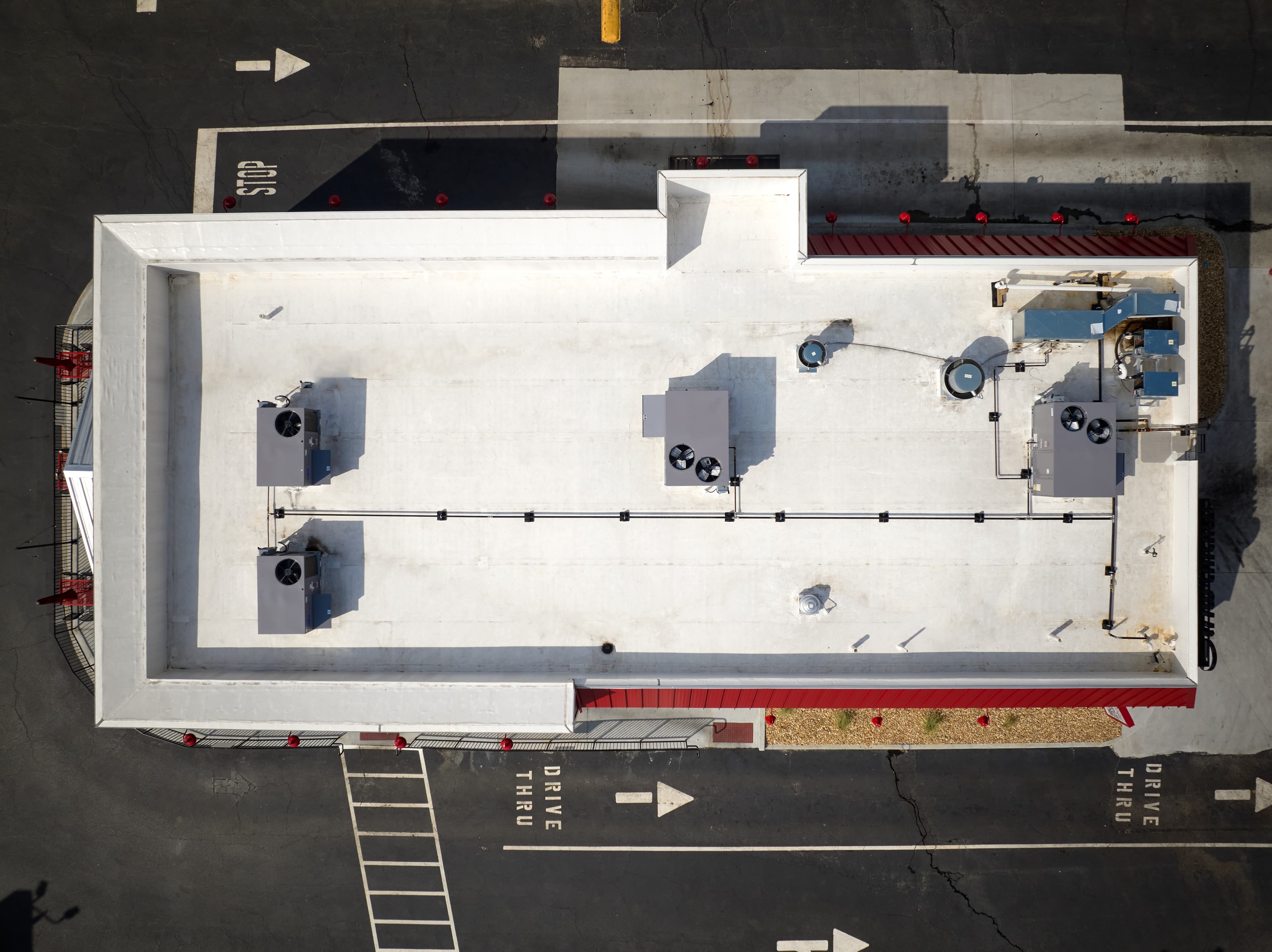 Aerial images of Slim Chickens restaurant's newly-installed commericial roof. HVAC units are also present on the roof.