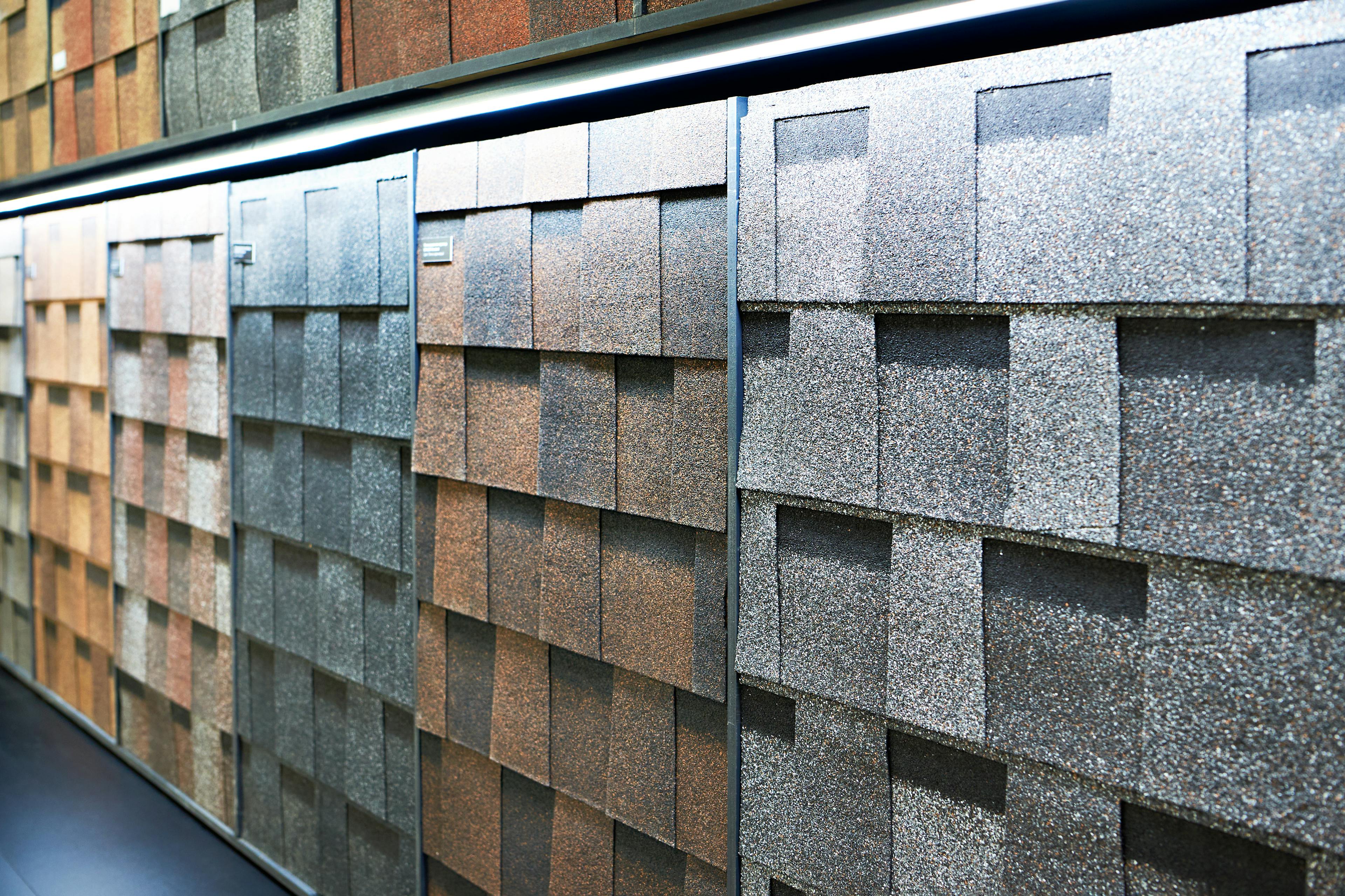 Laminate roof tiles for decorative finishing on display in store.